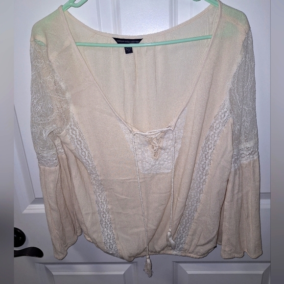 An American Eagle sheer and lace low-cut blouse in a size medium. - Picture 1 of 9